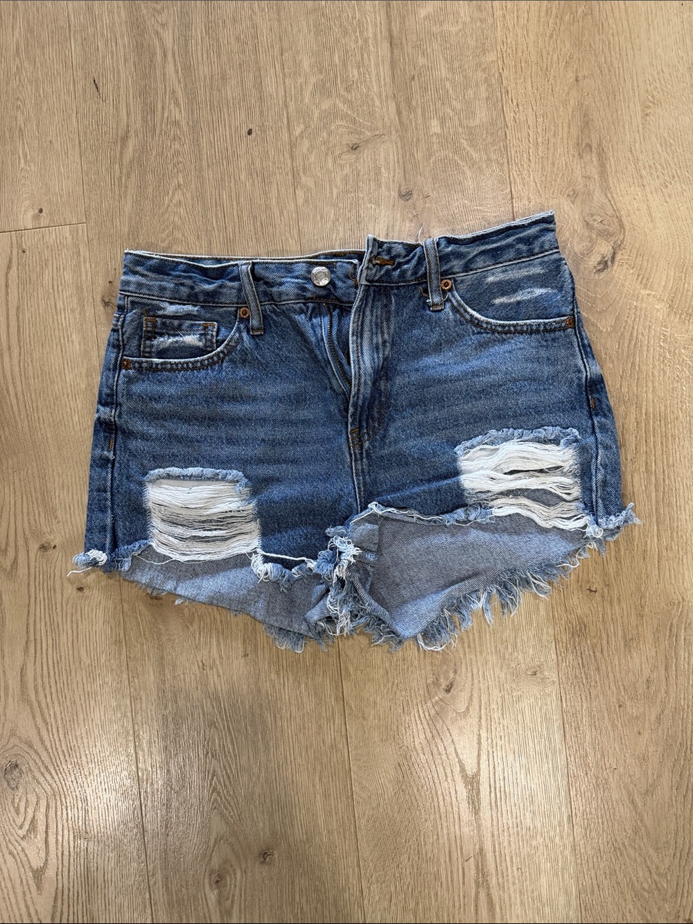 High-Rise Distressed Denim Shorts in Blue